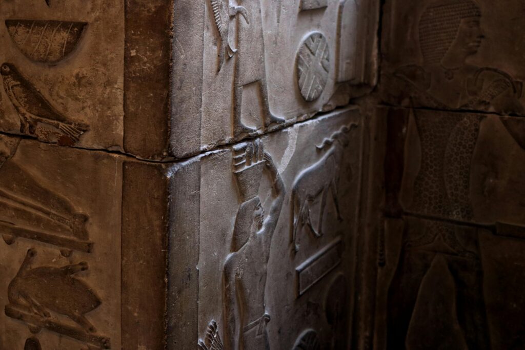 Close-up of detailed ancient Egyptian stone carvings in a Cairo museum showcasing cultural art and architecture.